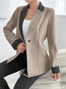 Détail d'un blazer kaki cintré avec revers noirs contrastés et bouton unique élégant