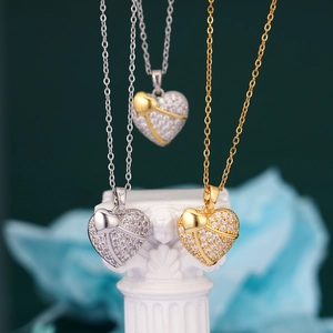 Classic 18K gold and silver heart pendant necklaces with pave-set cubic zirconia on a column
