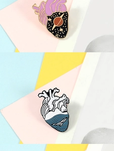 Detail of creative heart enamel pins featuring starry sky and ocean whale designs