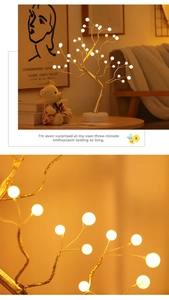 Close-up detail of warm LED glowing pearl tree lamp with elegant gold foil branches
