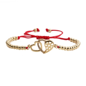 Adjustable red rope bracelet with double golden hearts and shimmering zircon stones