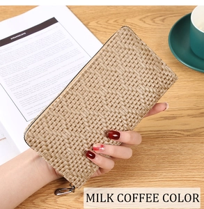 Macro detail of milk coffee leather clutch featuring a woven texture and metal zipper