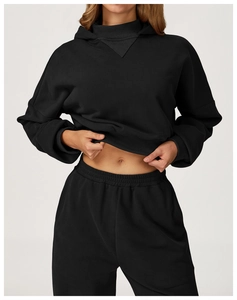 Detail of ribbed cuffs on black oversized hoodie and elastic waistband on sweatpants
