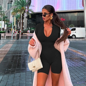 Outdoor street style shot of a sexy black V-neck bodycon bodysuit with short sleeves