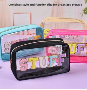 Detail of transparent PVC makeup bags with chenille patches and gold metal zippers