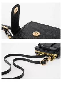 Detail view of gold magnetic buckle and zipper hardware on black leather crossbody bag