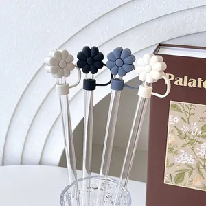 Daisy flower straw cover set in four colors on a minimalist white geometric background