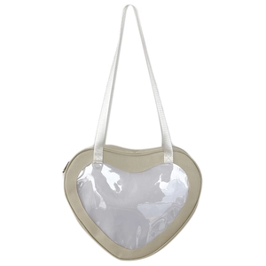 Detail view of heart-shaped beige crossbody bag with clear window for ita bag display