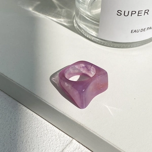 Minimalist purple acetate resin ring with marble texture on a clean white surface