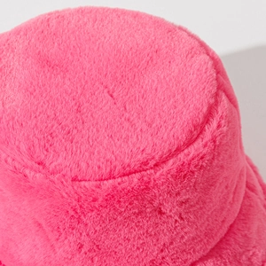 Close-up of the plush rose pink faux fur texture and stitching on top of the bucket hat
