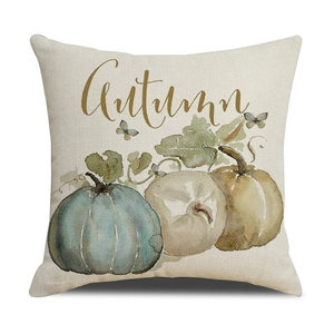 Macro detail of linen harvest pillow case featuring three pumpkins and Autumn script text