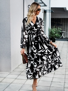 Detail of V-neck long sleeve floral dress with abstract print and ruffled hemline
