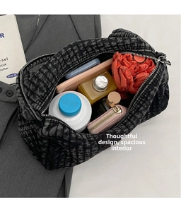 Spacious interior of dark gray denim tote bag showing items like water bottle and wallet