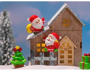 Detailed view of resin Christmas miniatures with Santa and tree for micro landscape DIY