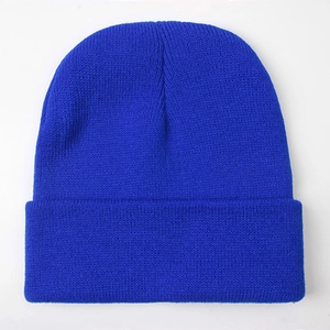 Detail of royal blue knitted beanie showing high-quality yarn texture and classic cuff design