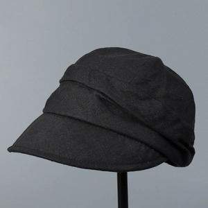 Detailed close-up of breathable black linen sun hat featuring stylish pleated crown texture
