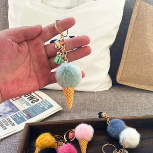 Close-up of mint green plush ice cream keychain with waffle cone and heart pendant