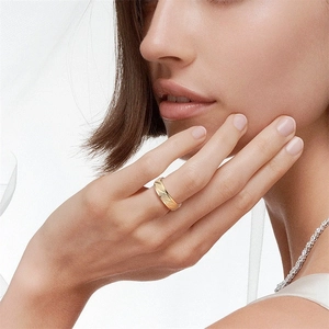 Close-up detail of a gold frosted titanium steel ring with elegant diagonal etchings