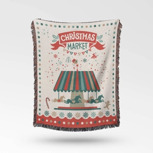 Detail of Christmas Market knitted blanket featuring festive tassels and woven texture