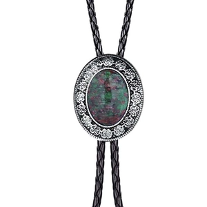 Vintage western bolo tie with green purple patterned agate stone and silver floral border