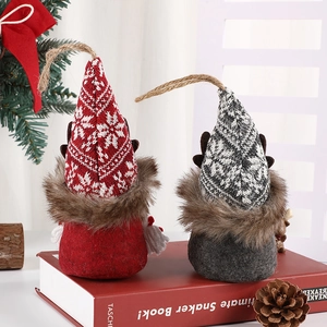 Christmas reindeer gnome ornaments with knit hats and antlers on red books