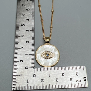 Detailed view of evil eye necklace pendant measuring 2.5cm with blue zircon stones