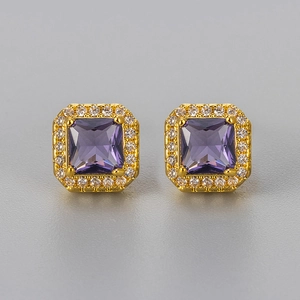 Macro detail of square purple zircon earrings with a golden halo setting and white stones