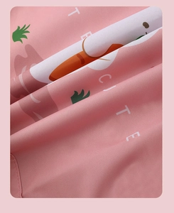 Close-up of pink Oxford cloth bag with cute carrot patterns and durable woven texture