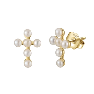 Macro detail of S925 silver cross earrings with round white pearls in gold finish