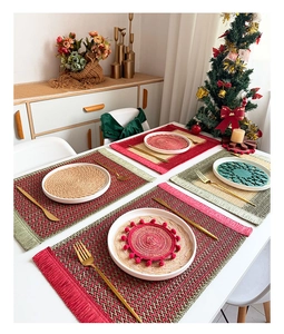 Close-up of festive red and green woven paper placemats and coasters for Christmas table decor