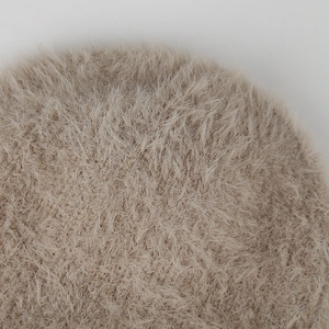 Close-up macro view of the soft fluffy faux fur material on this warm knitted hat