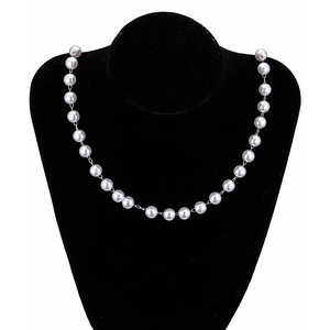 Faux pearl necklace with brass bead accents on black velvet bust stand for jewelry DIY