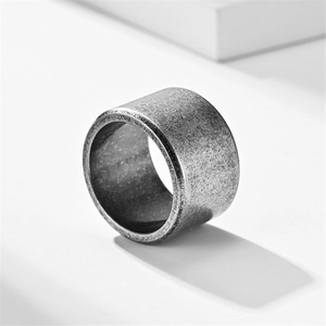 Macro detail of 10mm matte brushed titanium steel ring with a vintage distressed finish