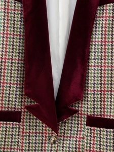Close-up of houndstooth wool blazer featuring elegant burgundy velvet lapel details
