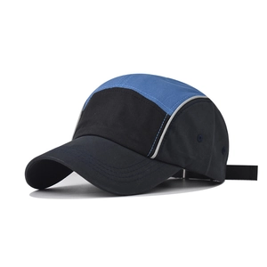 Detail view of cotton baseball cap with blue and black color-blocking and reflective trim