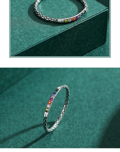 Macro shot of silver ring featuring rainbow zircons and snakeskin texture details