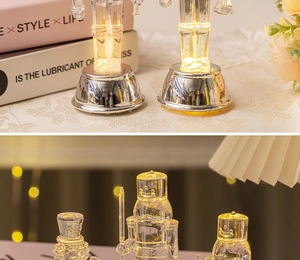 Close-up of a clear glass nutcracker figure with warm LED lights and silver base