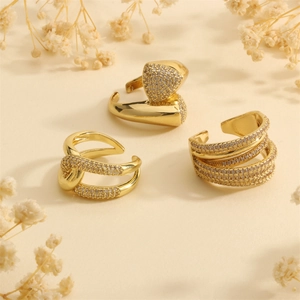 Three-piece gold plated layered rings with micro-set zircon on an elegant beige background