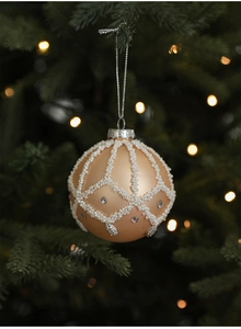 Detail of champagne gold Christmas ball with white beads and rhinestones on tree