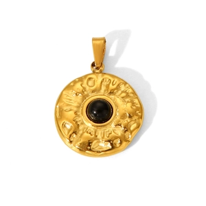 Macro view of golden hammered titanium steel pendant with central black natural stone