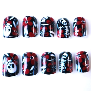 Short square press-on nails with dark gothic skull and red flower patterns on black