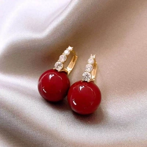 Gold plated hoop earrings with red sphere charms and sparkling cubic zirconia stones