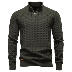 Detailed close-up of dark green waffle knit texture and half-zip collar on men's sweater