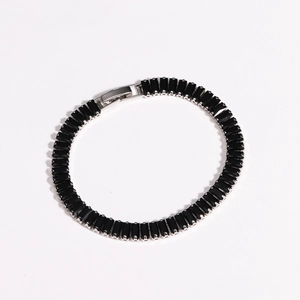 Detail showing colorful zircon bracelet with black rectangular stones and silver clasp