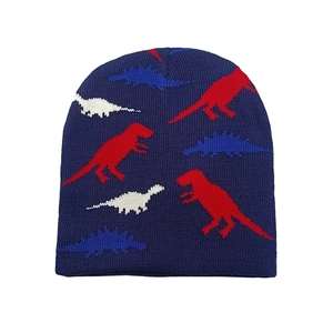 Detail view of navy blue knitted beanie featuring colorful dinosaur patterns and soft texture