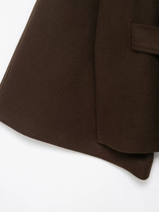 Detailed close-up of dark brown wool coat stitching and high-quality fabric texture