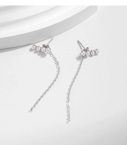 Macro shot of 925 sterling silver long fringe earrings with small white pearls