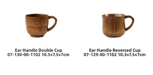 Close-up of vintage wooden mugs with ergonomic handles and smooth natural wood grain
