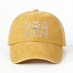 Close-up of yellow washed cotton baseball cap with DOG MOM embroidery and paw print detail