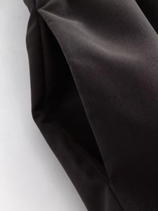 Detailed close-up showing the practical side pocket design of these black casual trousers